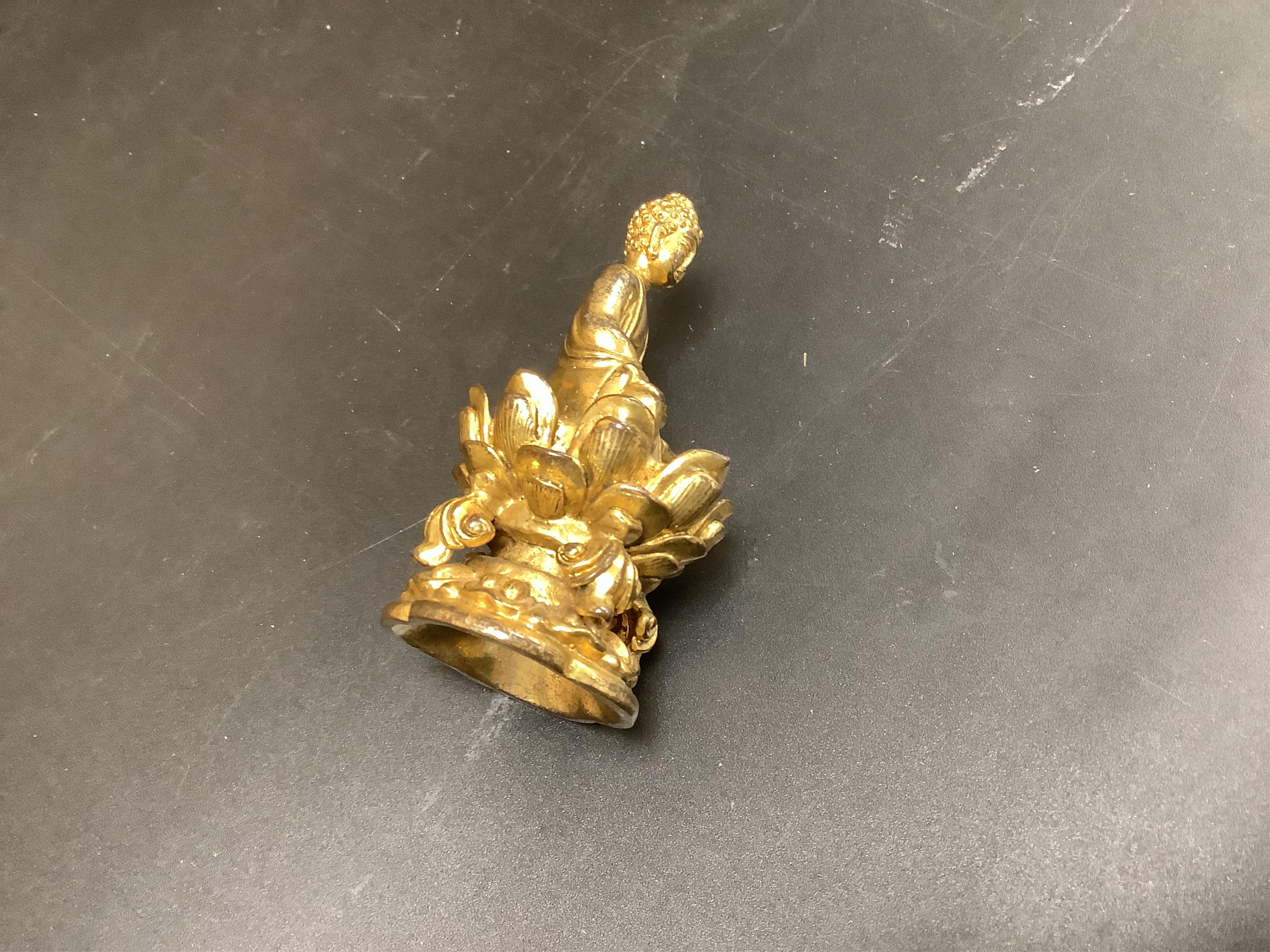 A Chinese miniature gilt metal figure of seated Buddha, 8cm high